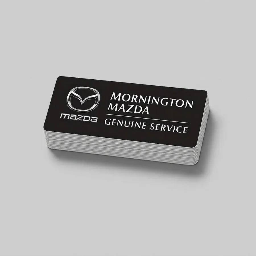 Stack of Mornington Mazda Genuine Service rear window stickers