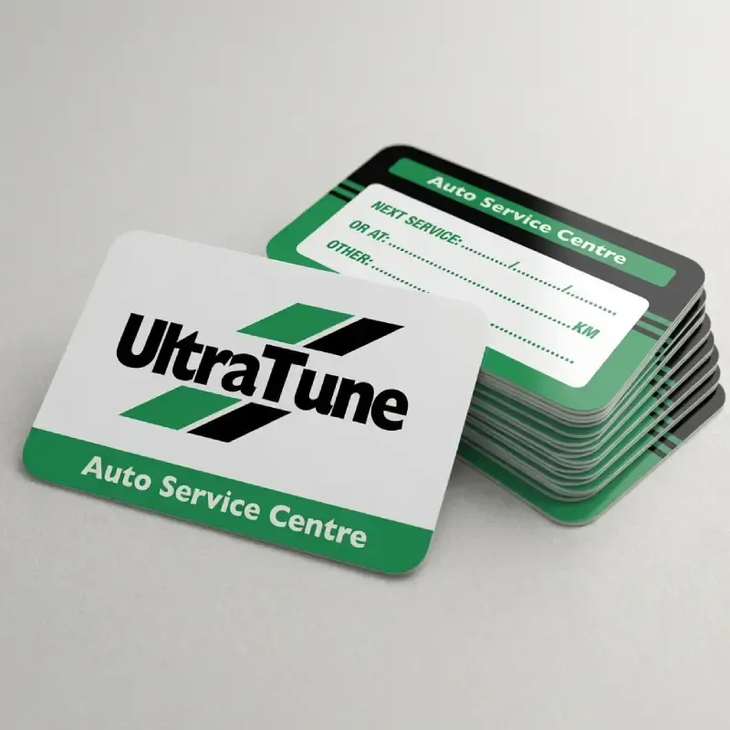 Stack of UltraTune branded service stickers