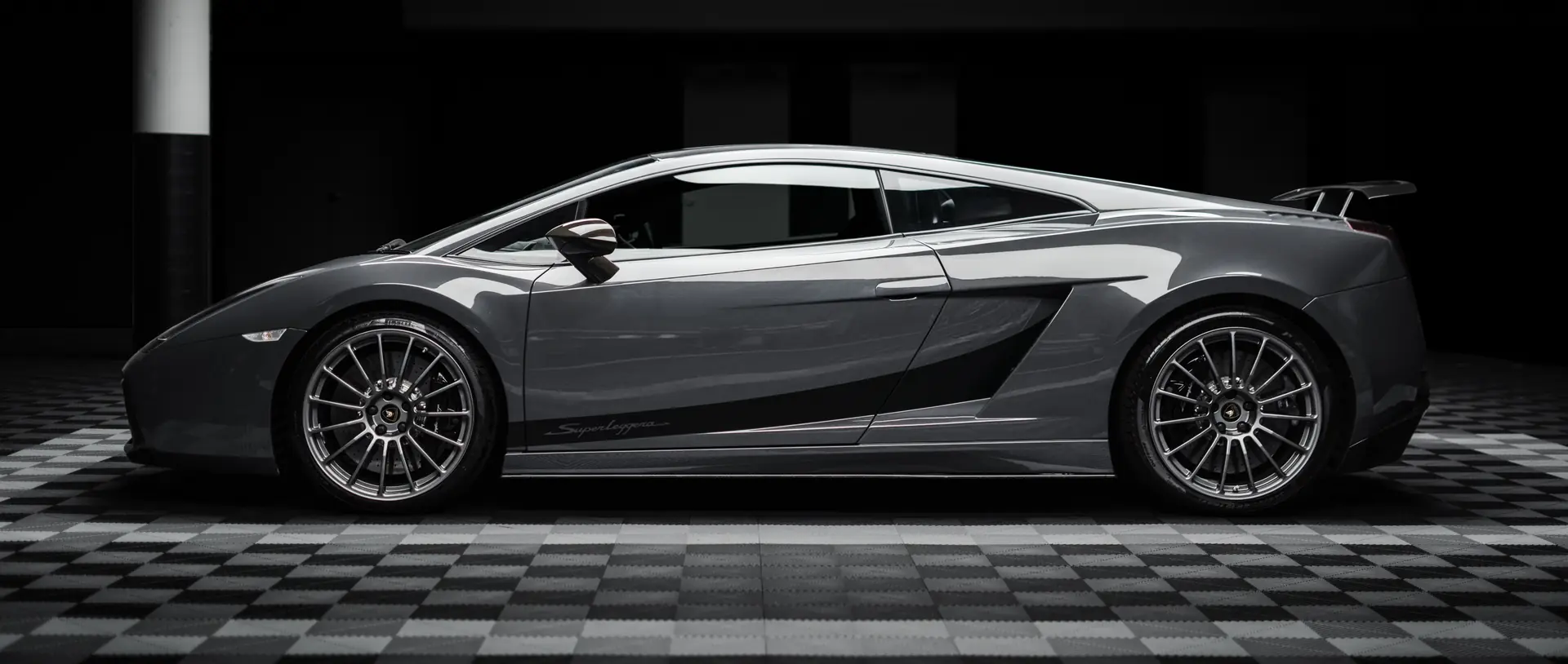 Silver sports car under studio lighting at the Ink workshop