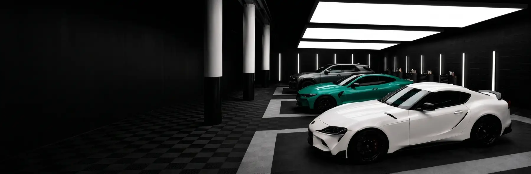 Wrap bay — Toyota Supra & BMW M4 under studio lighting